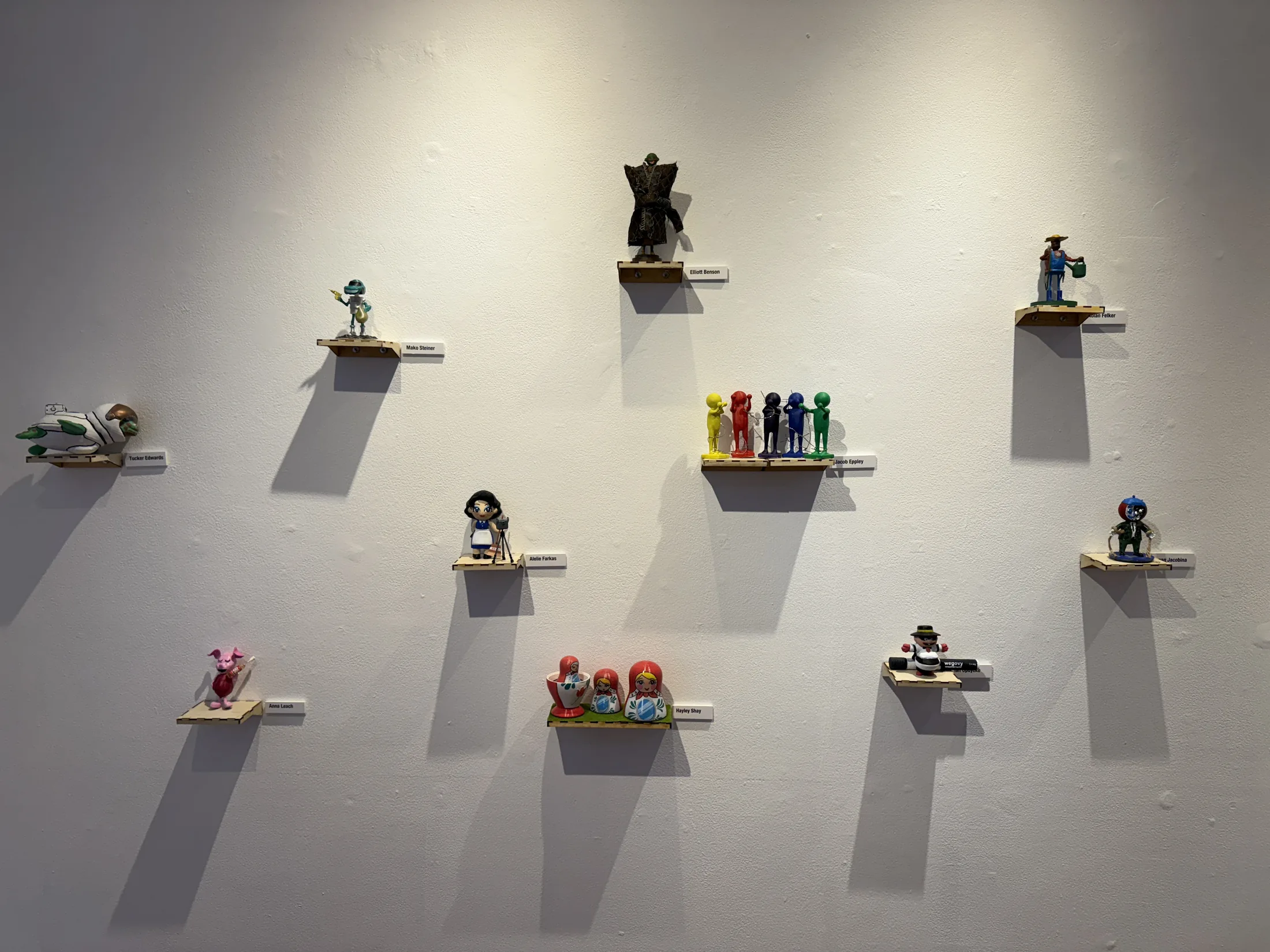 Wall display of small sculptural works in Pixels to Pieces.