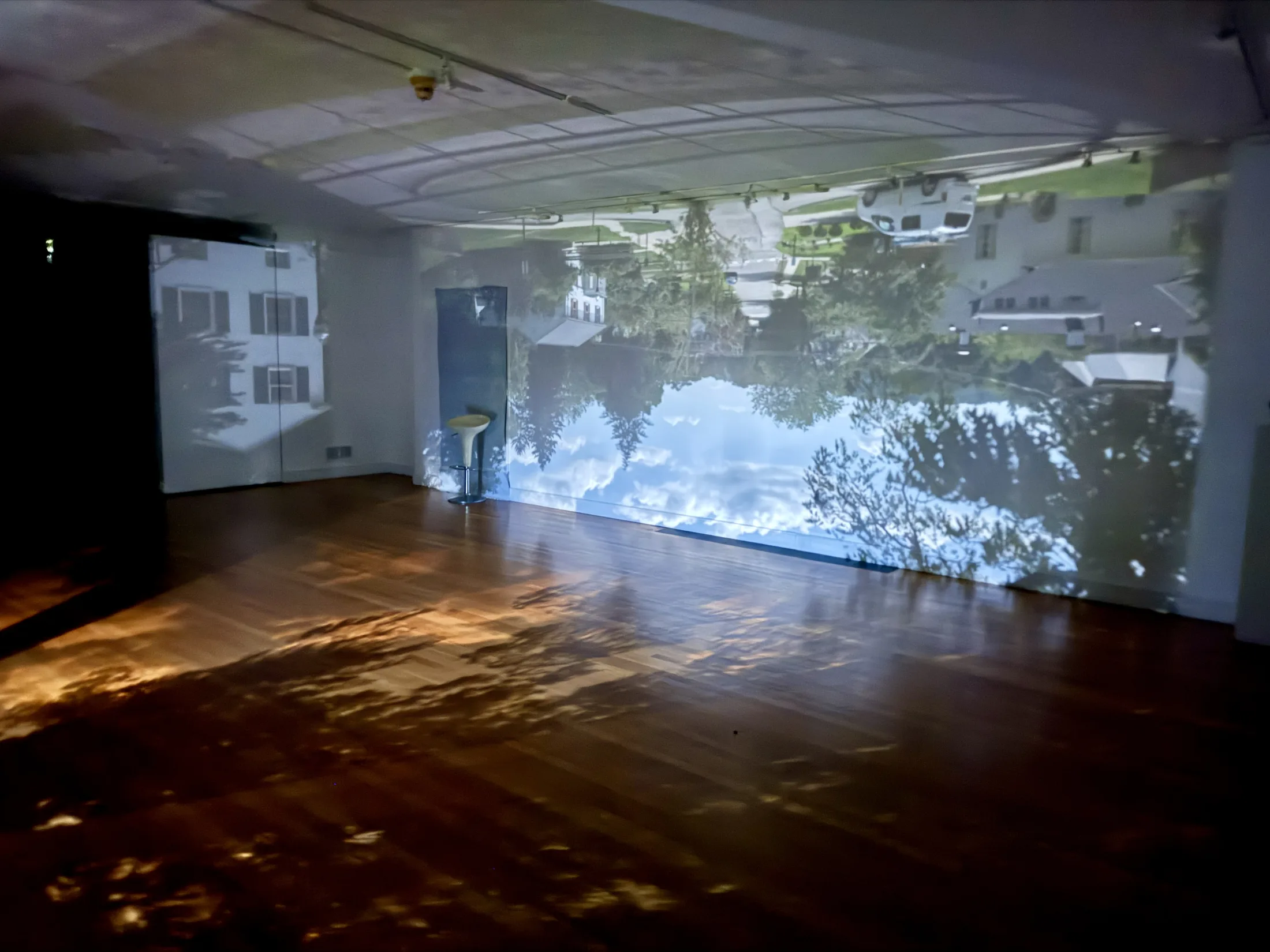 Gallery walls and floor filled with the inverted camera obscura projection.