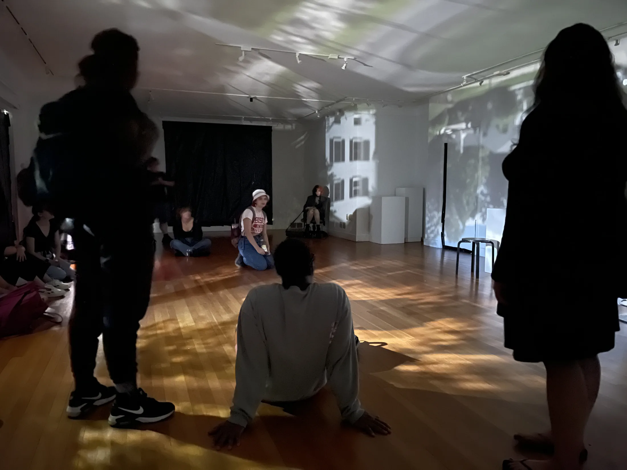 Visitors seated and standing inside the Camera Obscura installation.
