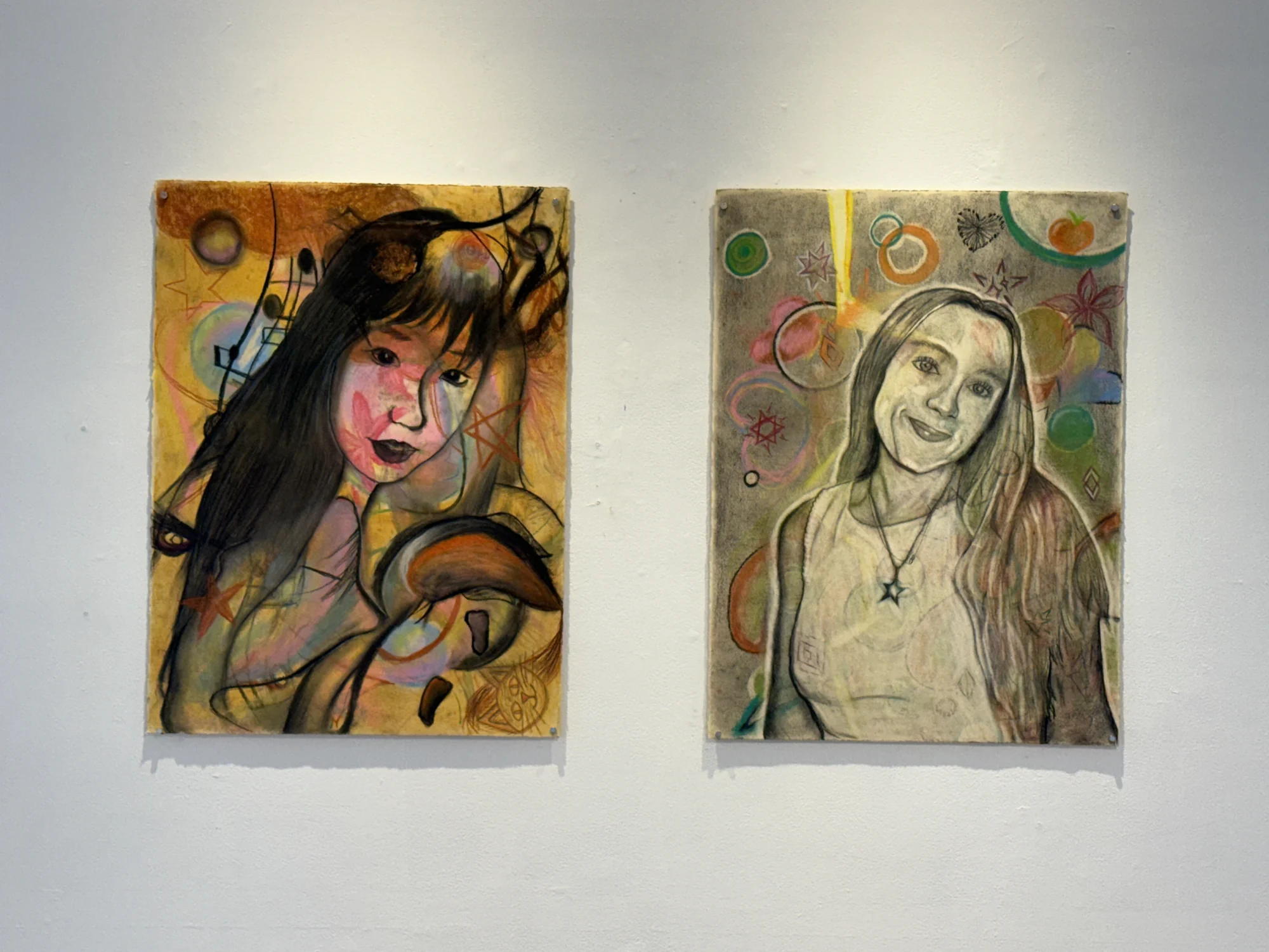 Two self-portrait drawings incorporating flowing lines and circular imagery.