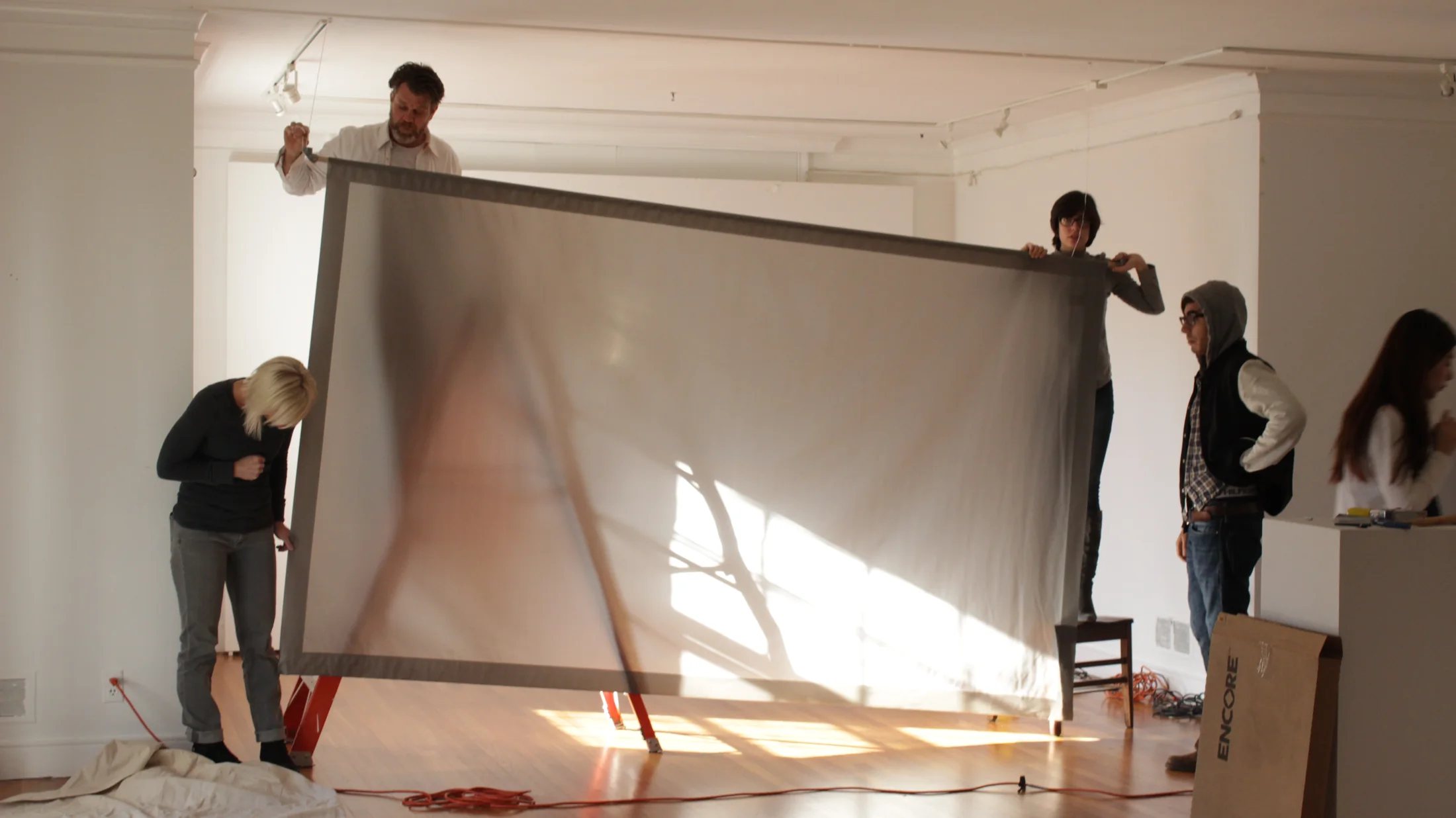 Gallery installation with artwork and open floor space.