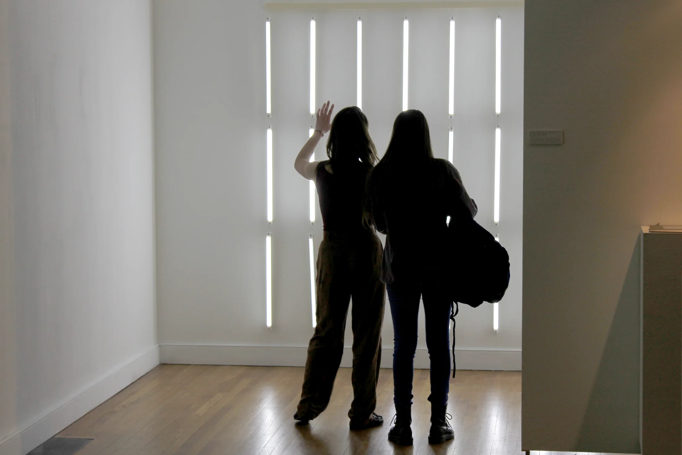 Gallery view with visitors moving through an exhibition.